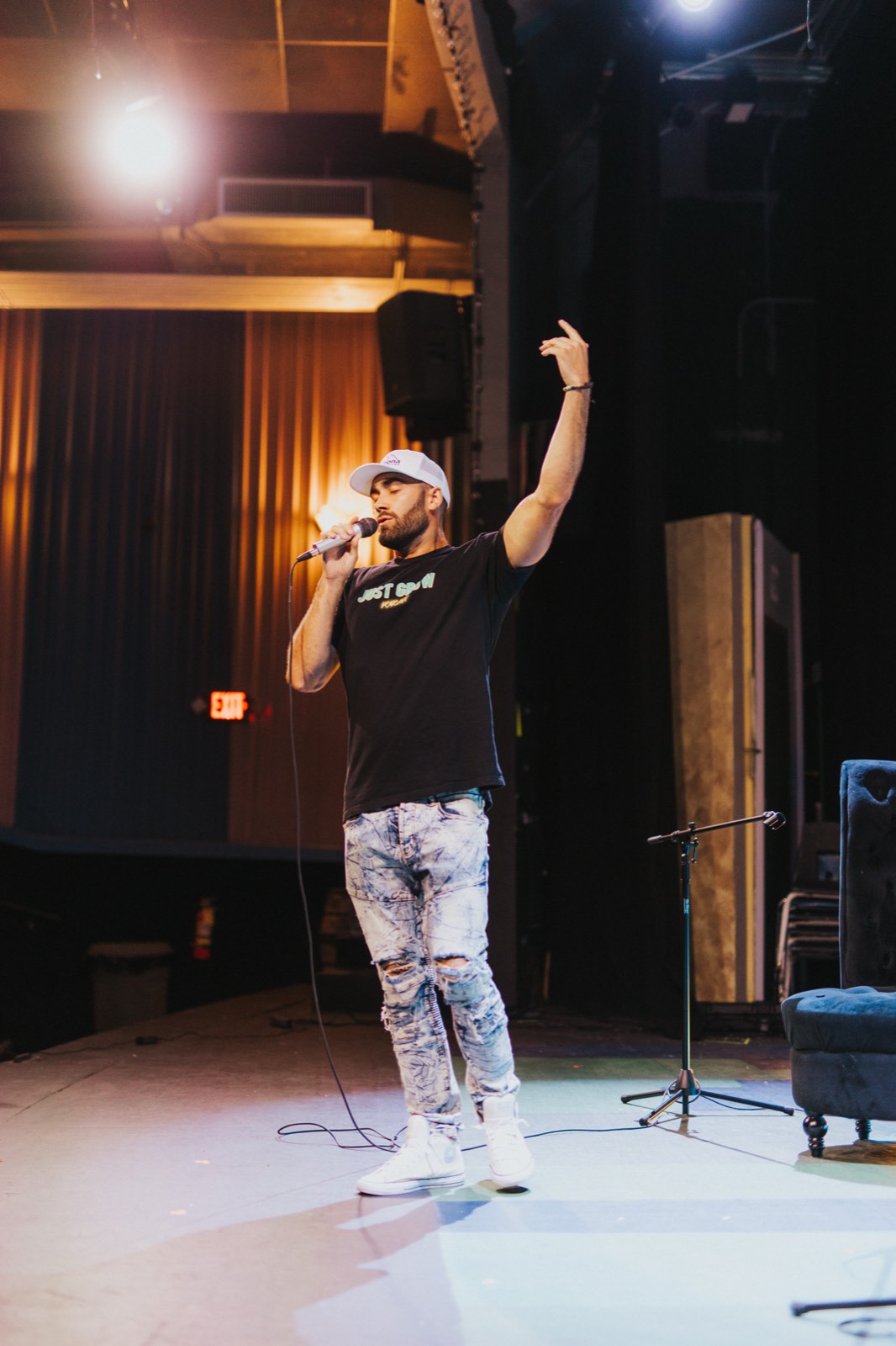 Ryan McBurney speaking on stage with a microphone