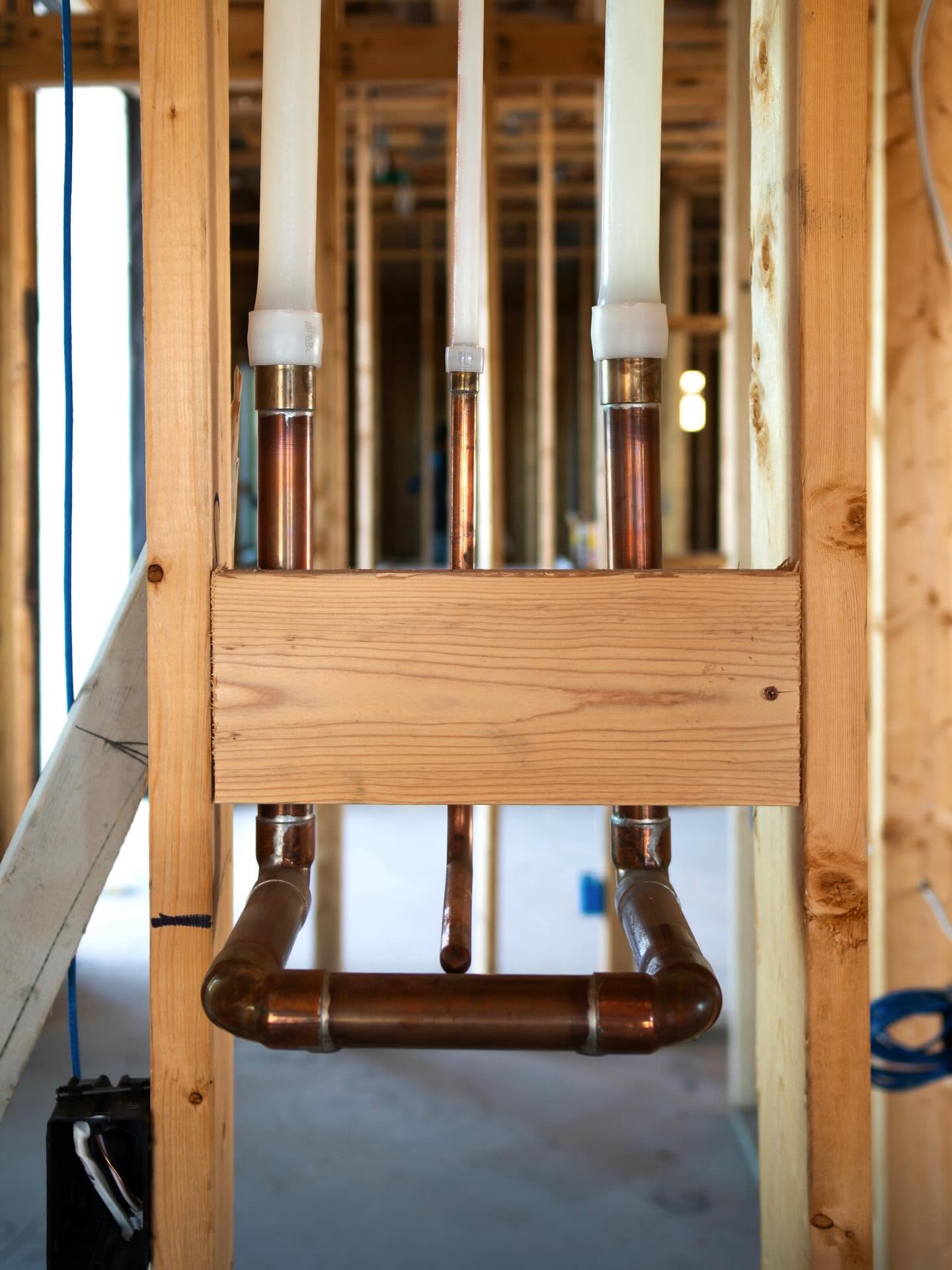 Clean copper stub-out and manifold work inside a framed wall
